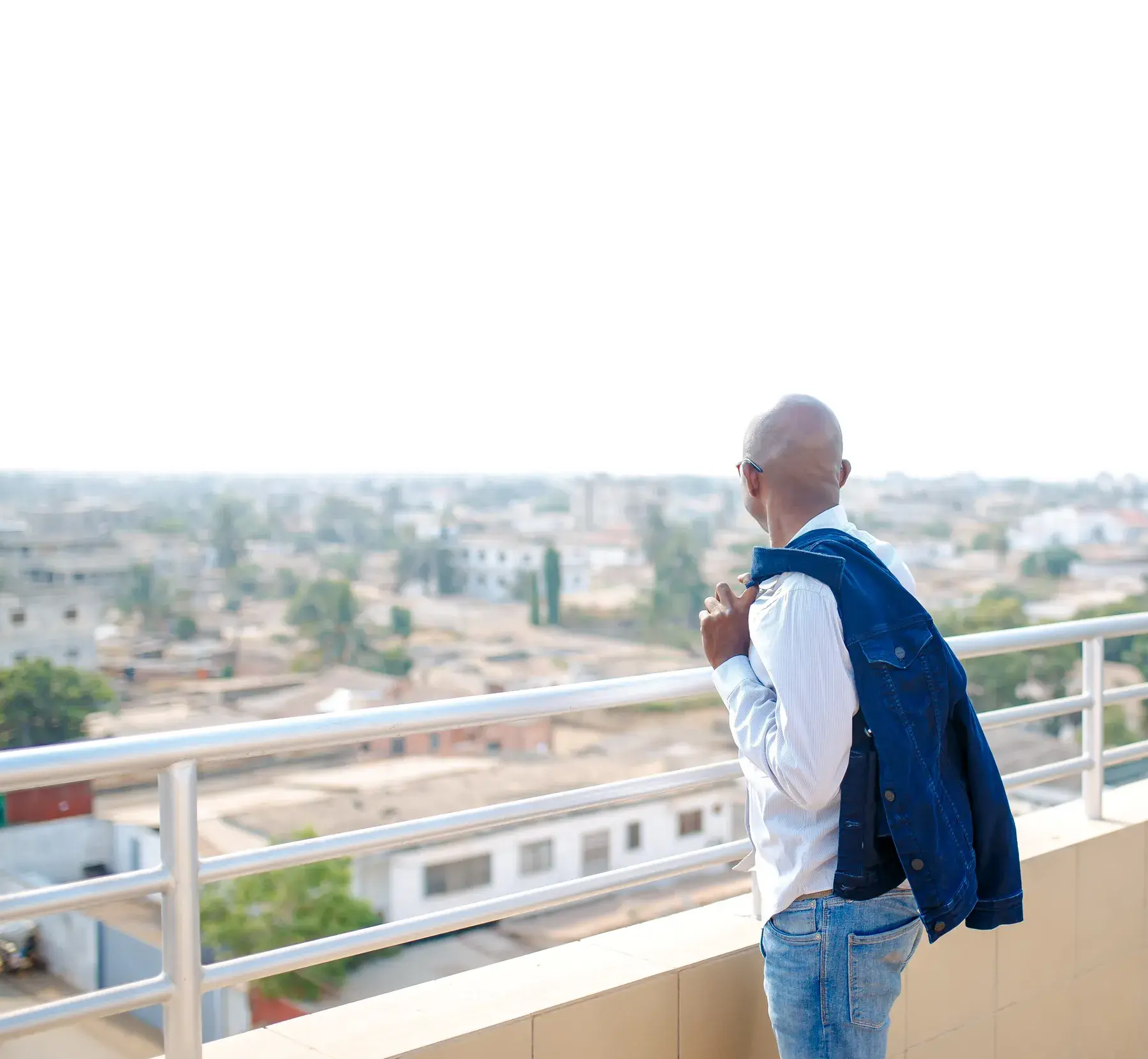 Richard Meseko on a balcony looking over the city.