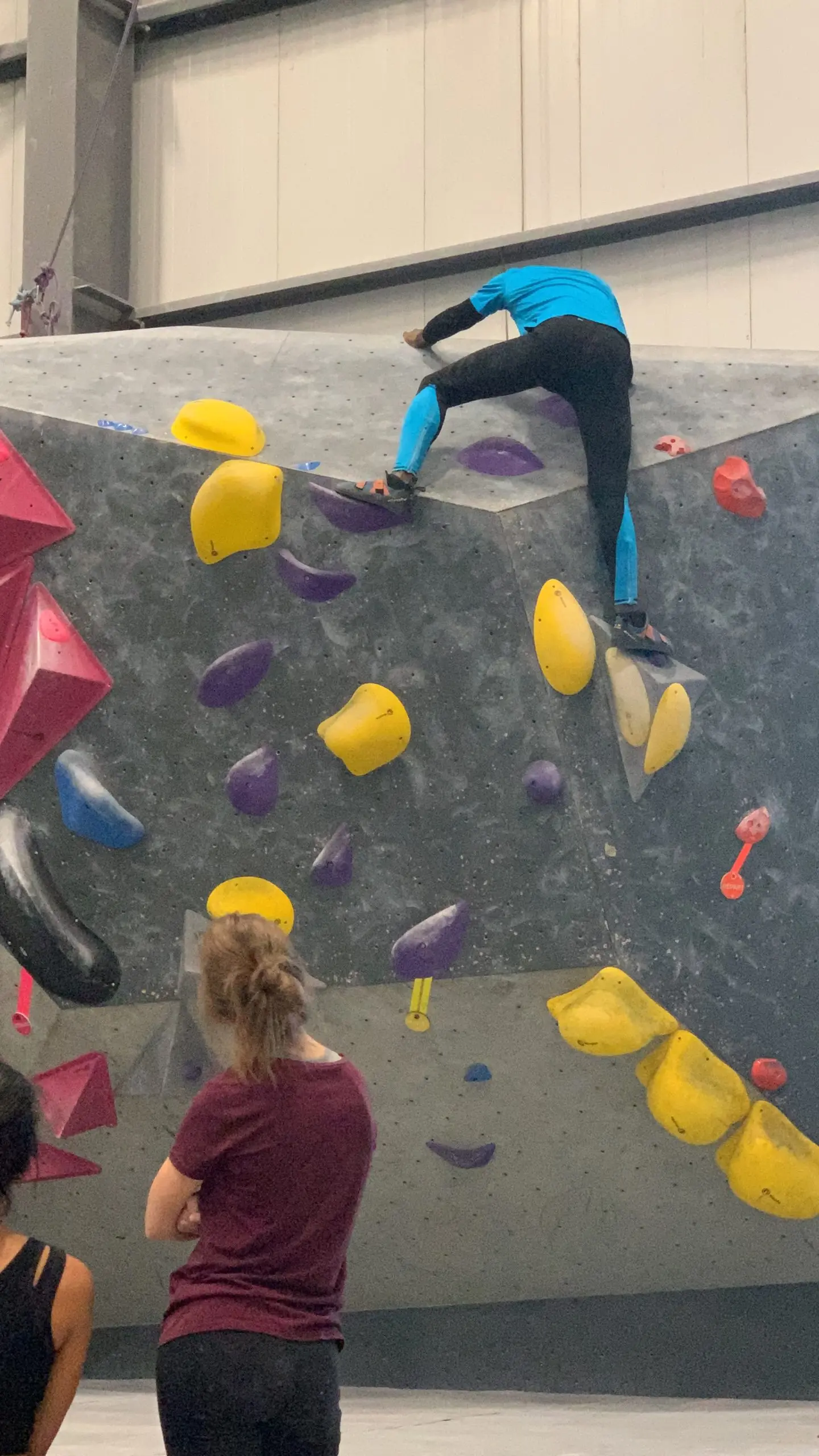 Richard Meseko climbing a bouldering wall.