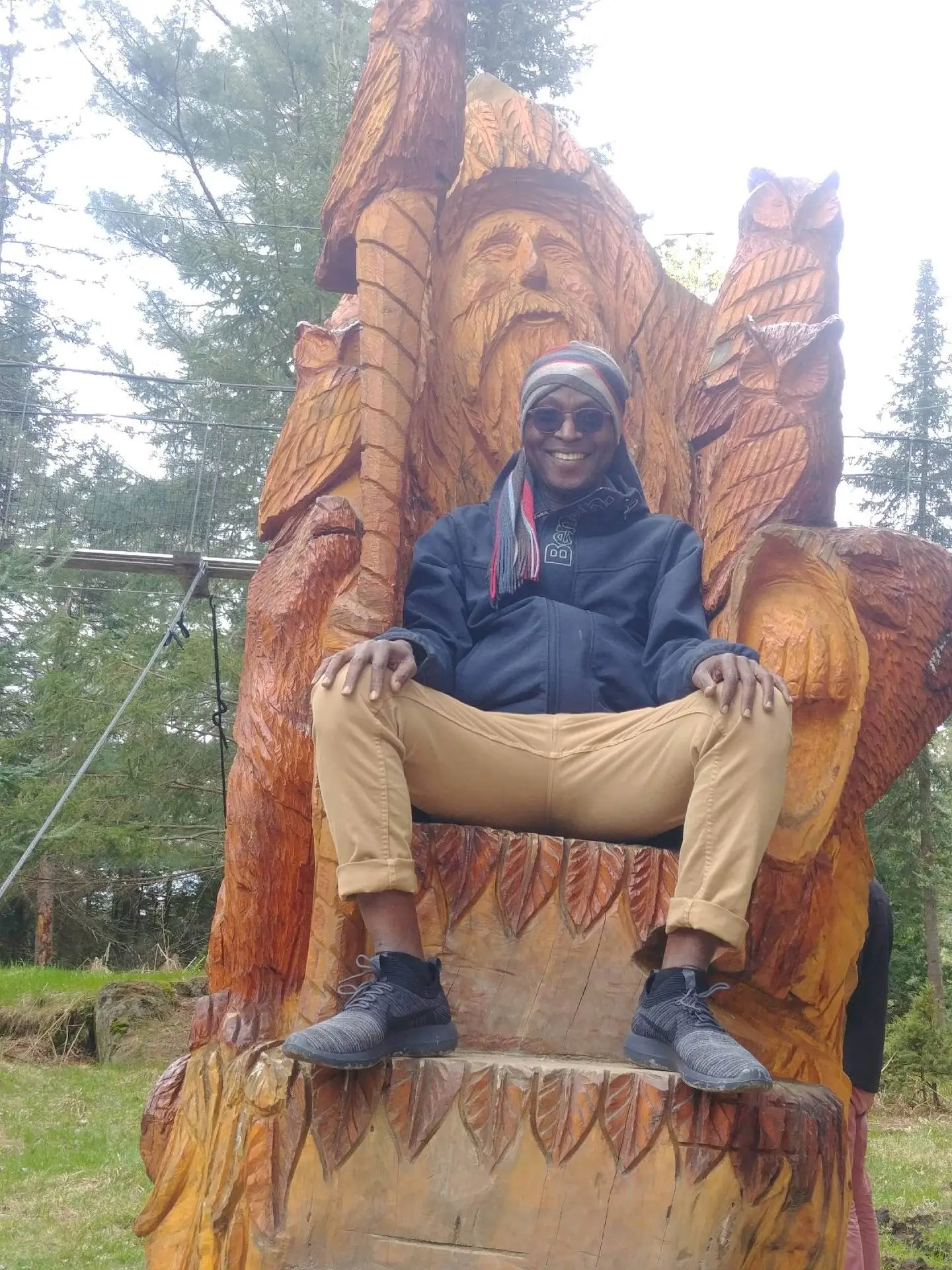 Richard Meseko seated on a carved wooden throne.