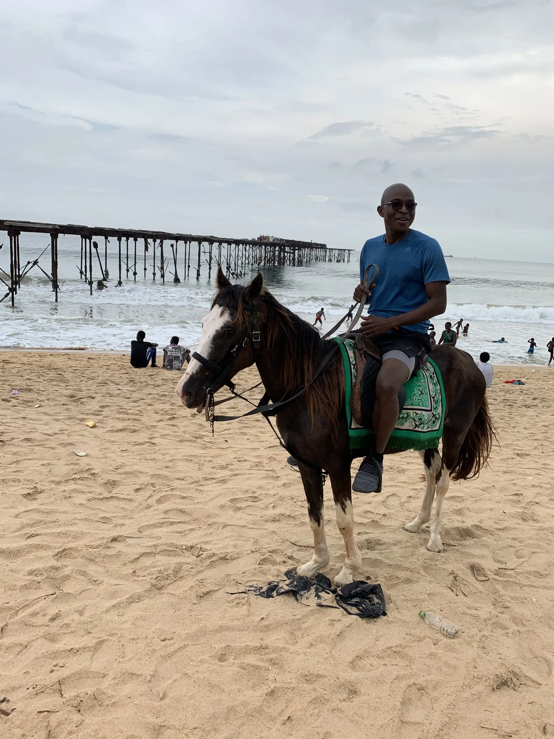 Richard Meseko on horseback on a beach.